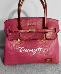 a pink handbag with the words dawg 21 on it